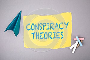 CONSPIRACY THEORIES. Text on note sheet, paper plane, symbol of gaining goals