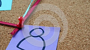 Conspiracy theory. The camera flies near a board studded with pins, pieces of paper and connected by threads.