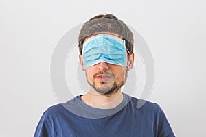 Conspiracy theory concept: Young man with face mask over the eyes