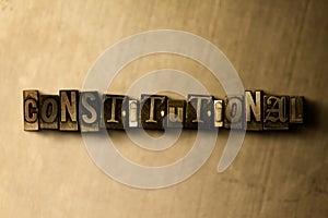 CONSTITUTIONAL - close-up of grungy vintage typeset word on metal backdrop