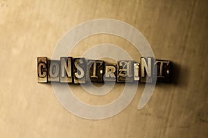 CONSTRAINT - close-up of grungy vintage typeset word on metal backdrop