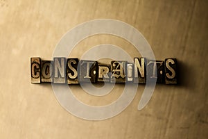 CONSTRAINTS - close-up of grungy vintage typeset word on metal backdrop