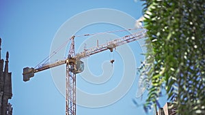 Construcion crane standing near La Sagrada Familia cathedral. Catholic church