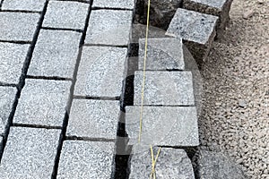 Construcion site of pavement granite cobblestone road in old city center installation or renovation repair. Roadworks