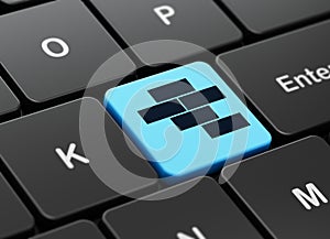 Constructing concept: Bricks on computer keyboard background