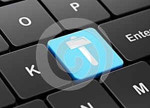 Constructing concept: Hammer on computer keyboard background
