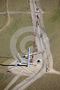 Constructing an electricity generating wind mill.