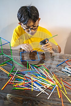 Constructing with lots of colorful plastic sticks. fun with building geometric figures and learning mathematics at home.