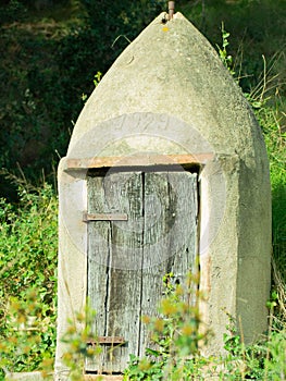 Construction of 1929 with wooden door of that time protecting an old natural water well