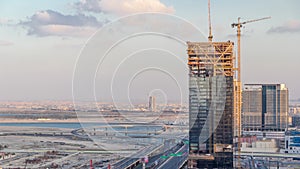 Construction activity in Dubai downtown with cranes and workers timelapse, UAE.