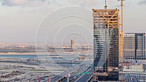 Construction activity in Dubai downtown with cranes and workers timelapse, UAE.