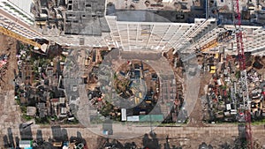 Construction of an apartment building filmed from the air. Copter rises to the top near the house
