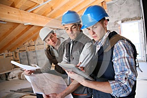 Construction apprentices working on plans