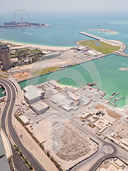 Construction of an artificial island Palm Jumeirah with construction equipment in Dubai.