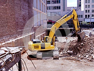 Construction backhoe clearing a basement pit