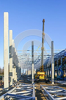 Construction of the body of a modern factory, assembly of metal trusses