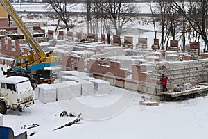 Construction of brick low-rise buildings in a new neighborhood. Residential complex in an eco-friendly area in winter