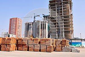 Construction bricks against the background of multi-story buildings under construction. The concept is a building material.