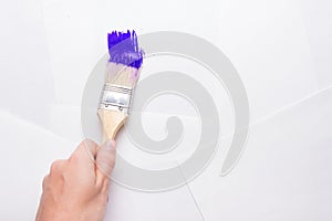 Construction brush in hand on white background. not isolated