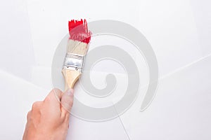Construction brush in hand on white background. not isolated