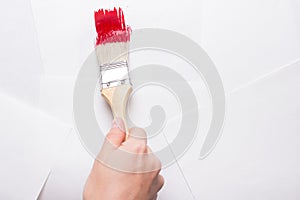 Construction brush in hand on white background. not isolated