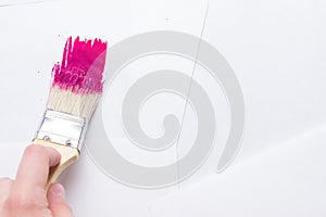Construction brush in hand on white background. not isolated