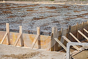 construction of building foundation with reinforced concrete pouring on construction site