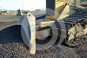 A construction bulldozer moving gravel