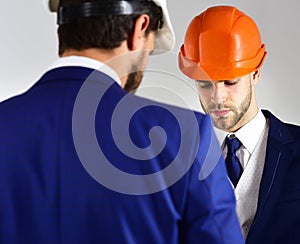 Construction, business people, architecture concept. Businessman and engineer back view.