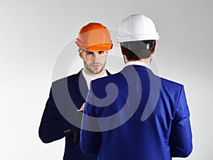 Construction, business people, design concept. People in helmets isolated on white background.