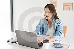 Construction business plan concept, Female architect is drawing house plan of project on laptop