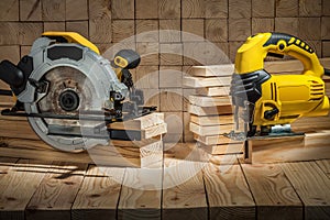 Construction carpentry tools electric corded circular saw and jigsaw on wooden background