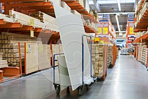 construction cart in the building store. Carts loaded with boards. shop of building materials. Racks with boards, wood and