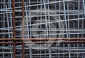 Construction: Close up of galvanised welded steel square mesh and rusty rebar mesh. 2