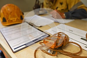 Construction coal miner supervisor conducting safety checking on job hazards analysis on confined space permit before sign off photo