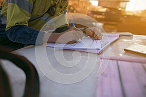 Construction coal miner supervisor conducting safety checking on job hazards analysis on hot work permit before sign off