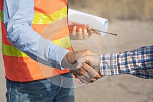 Construction company handshaking with material supplier