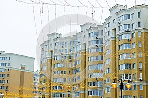 Construction complex with high rise yellow residental apartment buildings with many windows and balconies in city