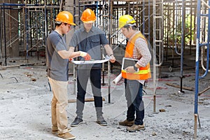 Construction concept of Engineer and Architect working with construction model and blueprint at construction site, Engineer and