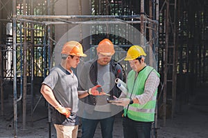 Construction concept of Engineer and Architect working with construction model and blueprint at construction site, Engineer and