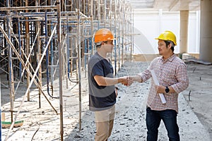 Construction concept of Engineer and Architect working with construction model and blueprint at construction site, Engineer and