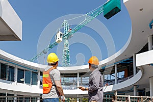 Construction concept of Engineer and Architect working with construction model and blueprint at construction site, Engineer and