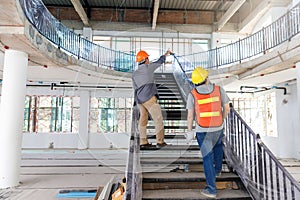 Construction concept of Engineer and Architect working with construction model and blueprint at construction site, Engineer and