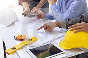 Construction concept of Engineer and Architect working at Construction Site with blue print, Engineer and Architect discussing