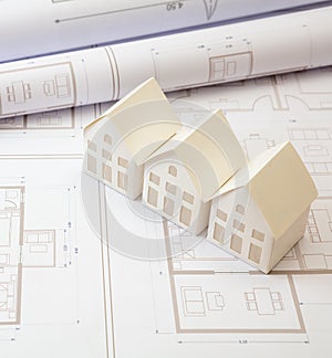 Construction concept. Residential building drawings and architectural house models on an office desk