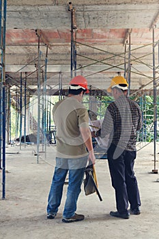 Construction concepts, Engineer and Architect working at Construction Site with blueprint,