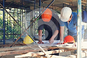 Construction concepts, Engineer and Architect working at Construction Site with blueprint