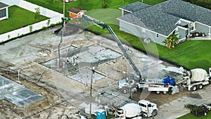 Construction of concrete foundation slab at new house developing site. Workers pouring concrete bedding ready for