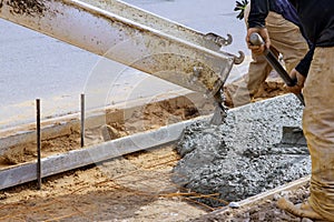 Construction of a concrete walkway around a residential rural house in manual of the pavement