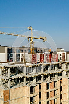 Construction and construction of high-rise buildings, the construction industry with working equipment and workers. View from